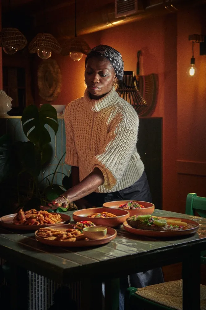 Adwoa arranges fusion dishes at Odo Kitchen